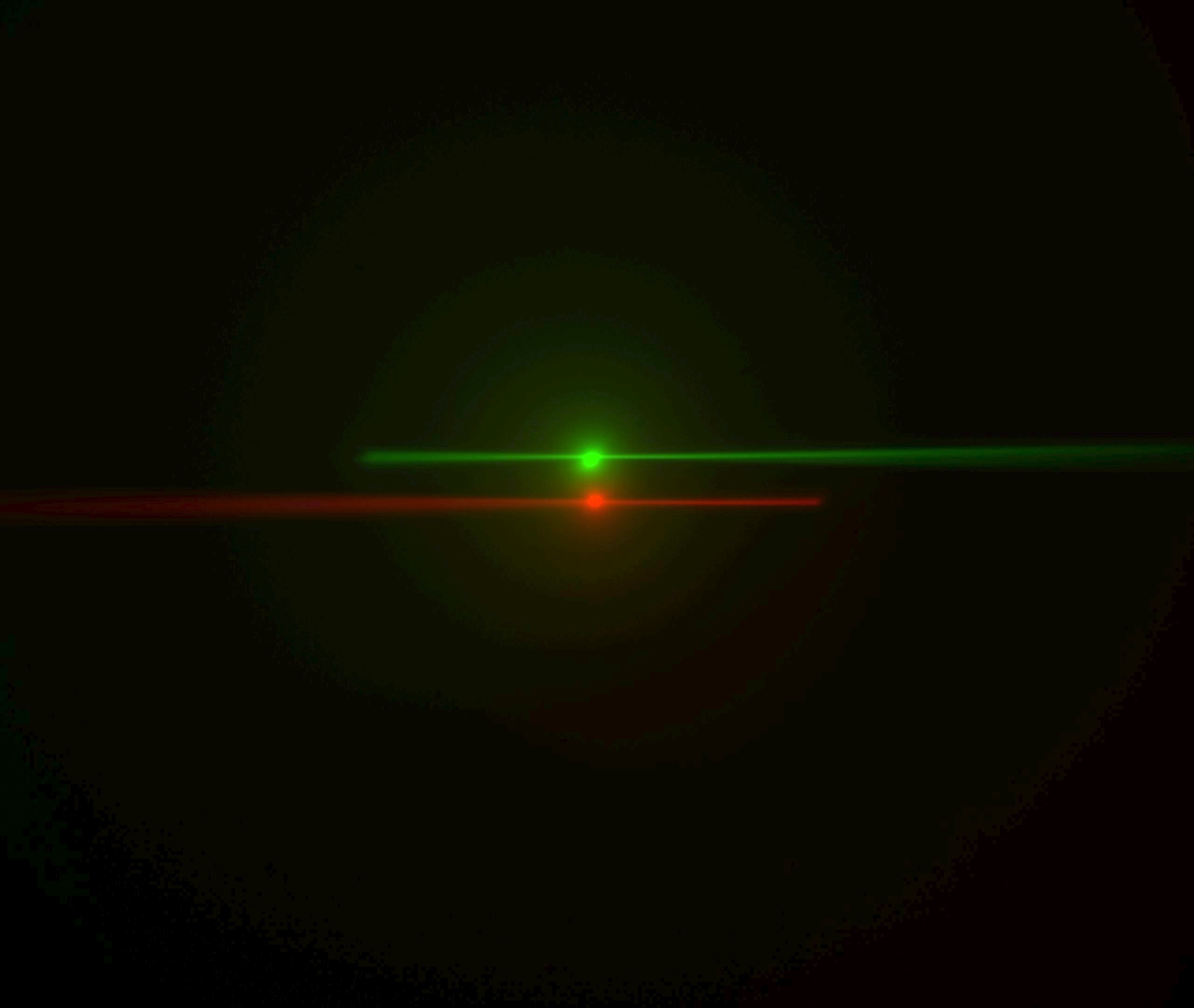  Laser beams seen by cameras in conventional orientation. The green image is from the left-side camera and shows the beam from the right-side scanner entering from the right and eventually stiking the coverslip where it stops. The red image is from "Path A" (the right-side camera and left-side scanner) with the beam entering from the left. The bright spots are the epi-fluorescent excitation from the scanner on the same side as the respective cameras. The following statement will be understood after going though the alignment: the objective lateral alignment is perfect because the epi and beams exactly overlap, but the camera mirrors need to be adjusted slightly to put both epi spots in the image center.